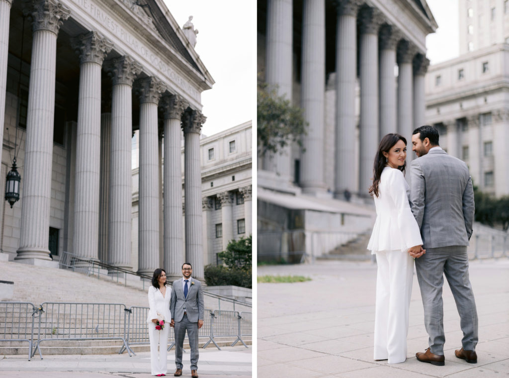 newlyweds, both wearing suits, pose near the steps of New York's City Hall after eloping