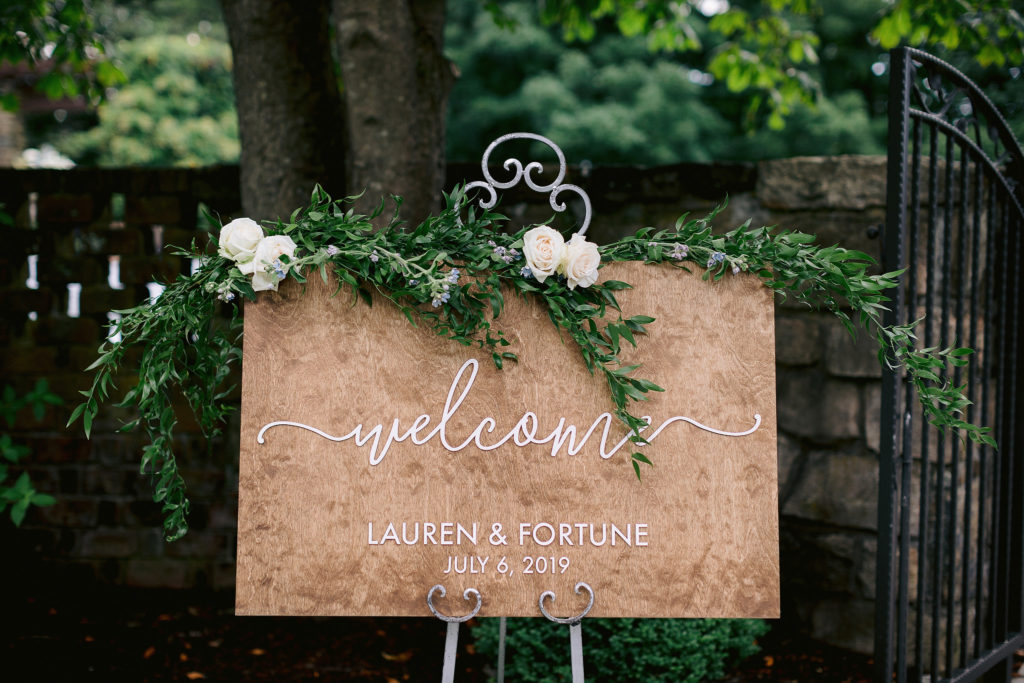 elegant welcome sign invites guests to Lauren and Fortune's wedding outside on the grounds of Le Chateau in South Salem New York