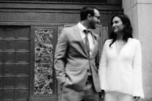 New York City Hall pictured behind a newlywed couple who have just eloped in New York City