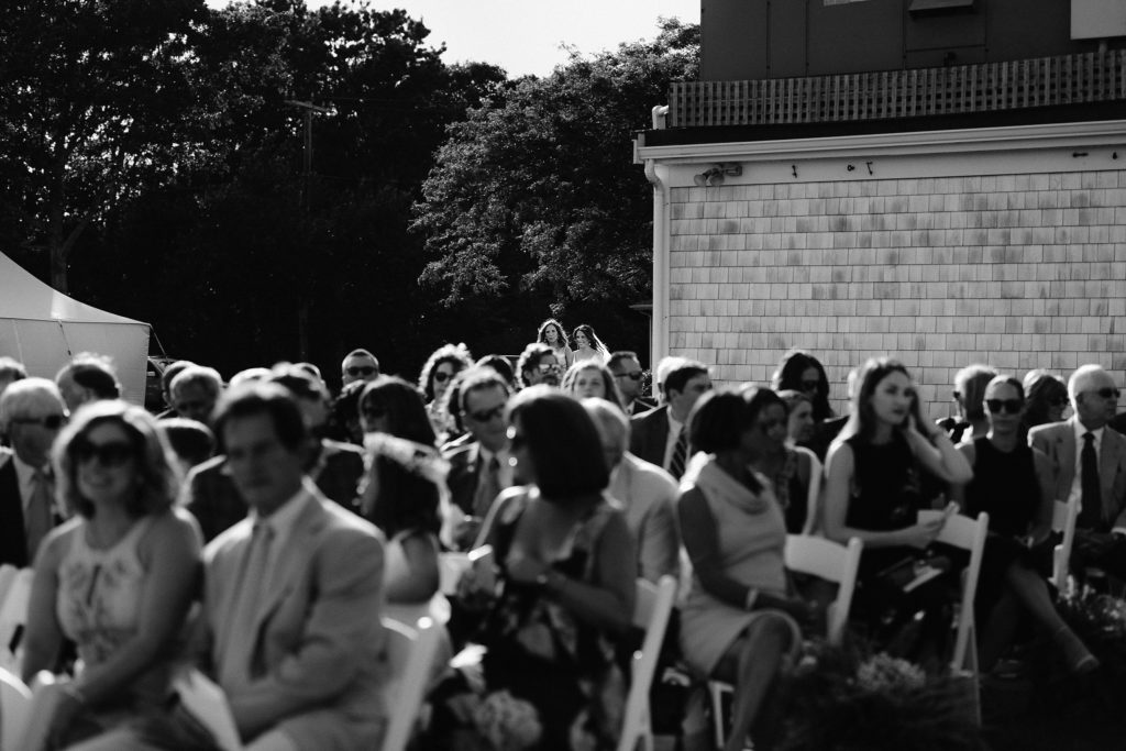 black and white shot of guests seated for an outdoor oceanside cape cod ceremony