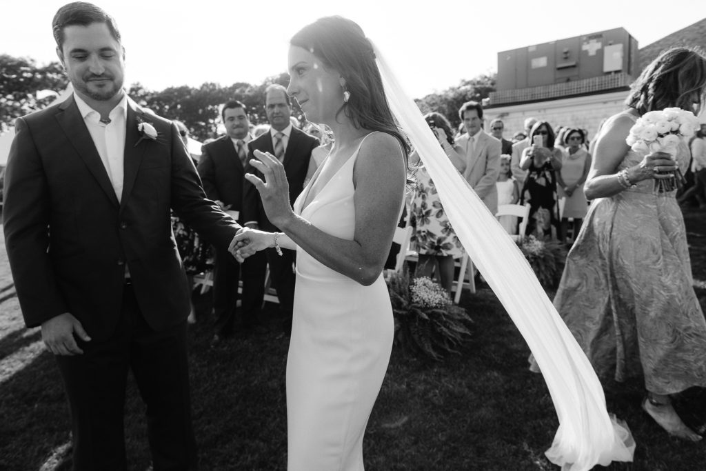 bride and groom prepare to run through their nuptials in this outdoor oceanside cape cod wedding
