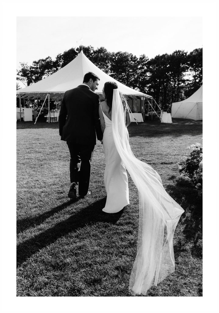 black and white photo of a bride and groom walking back down the aisle after they have just been married
