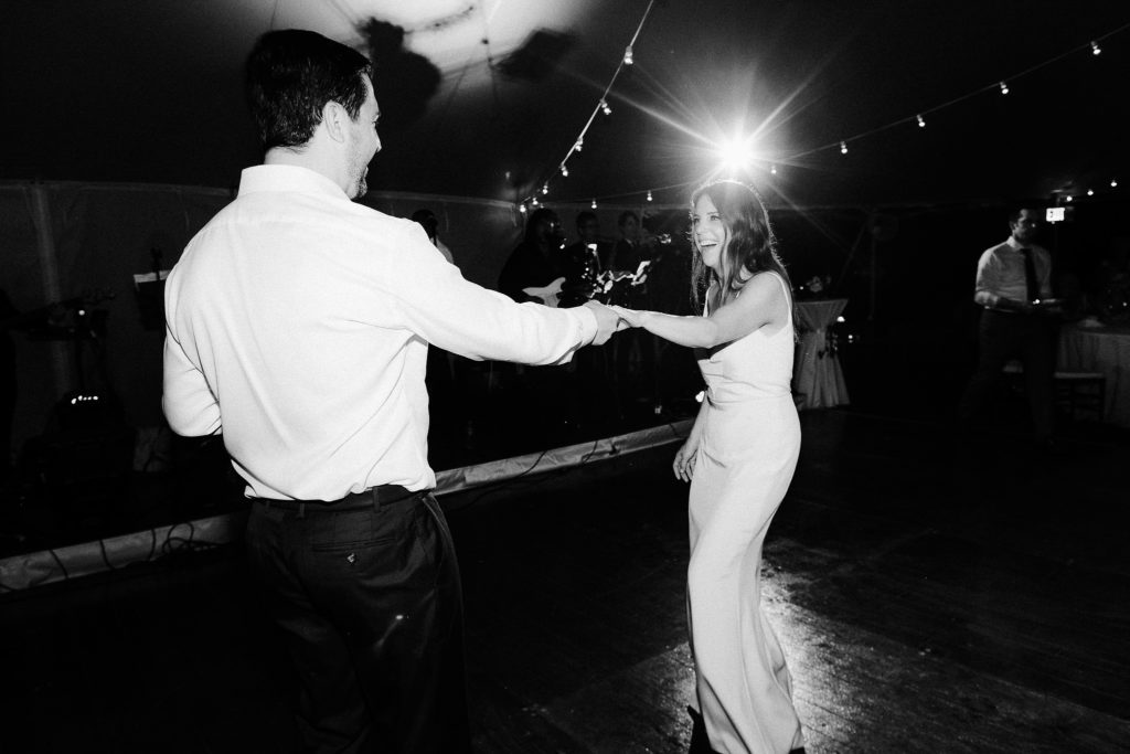 bride and groom ham it up on the dancefloor during their oceanside tent reception in cape cod