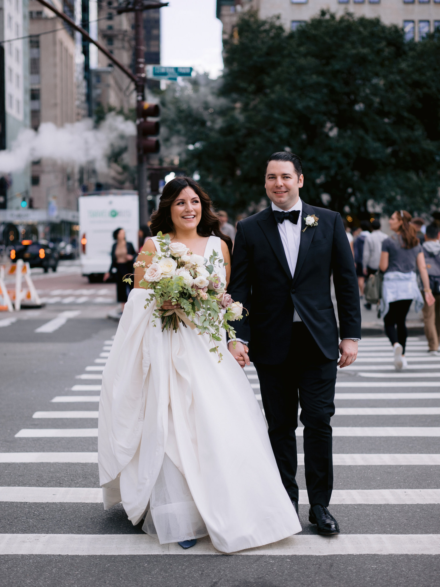 Bride and groom crossing a busy New York City intersection
