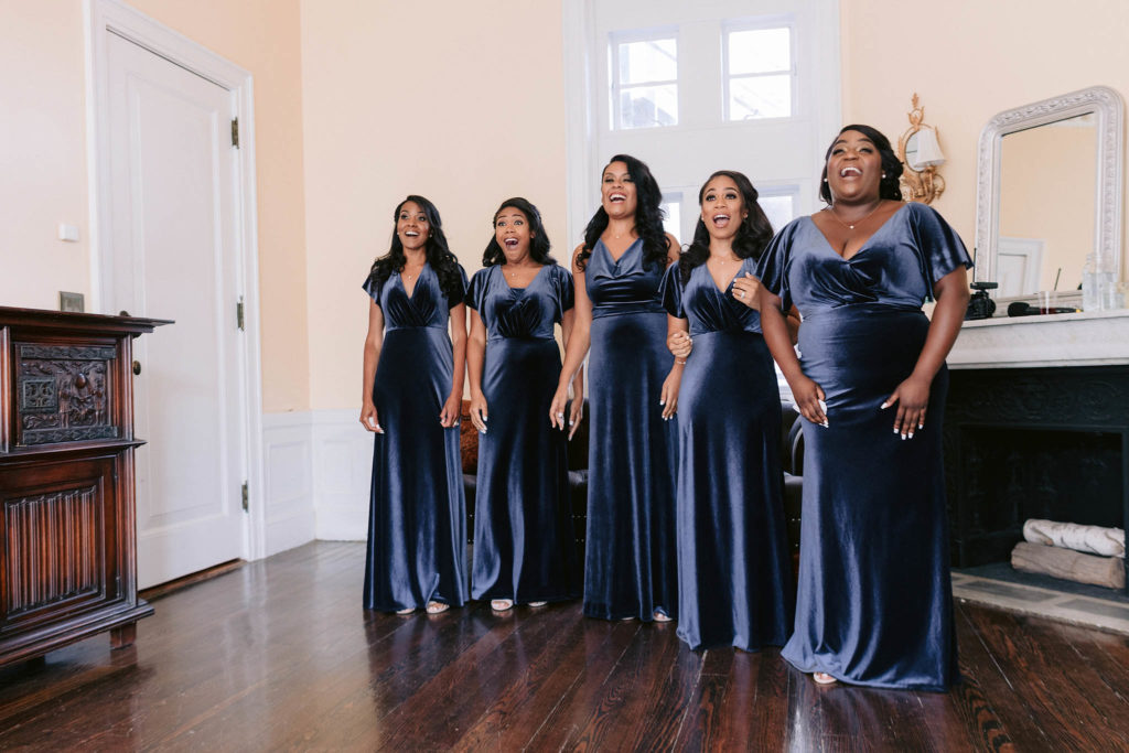 Bridesmaids see their friend and bride for the first time and exclaim with delight at how beautiful she looks. jenny fu studio
