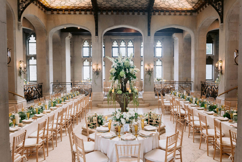 Reception venue at Castle Gould in new York showcases high ceilings, large windows and an elaborately-patterned sun roof