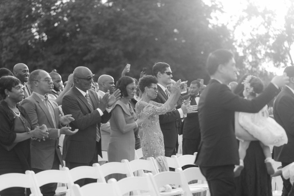 Guests celebrate the first kiss of a couple getting married on the grounds of Castle Gould in New York. images by Jenny Fu studio