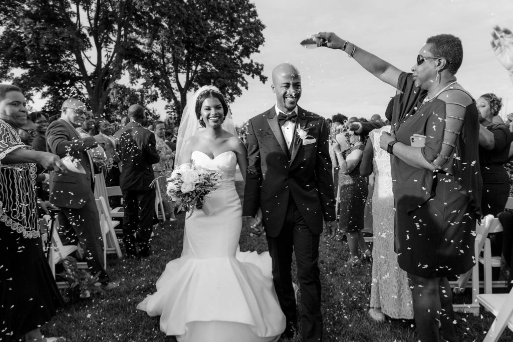 Jenny Fu studio captures Newlywed couple walks down the aisle to confetti and smiles at this New York wedding on the grounds of the Sands Point Preserve