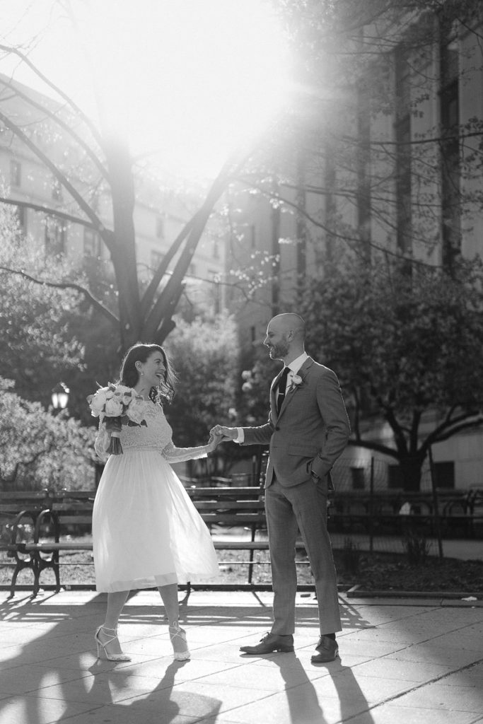 A new husband and wife celebrate their marriage at New York City Hall by sharing a first dance in the Wedding Gardens outside