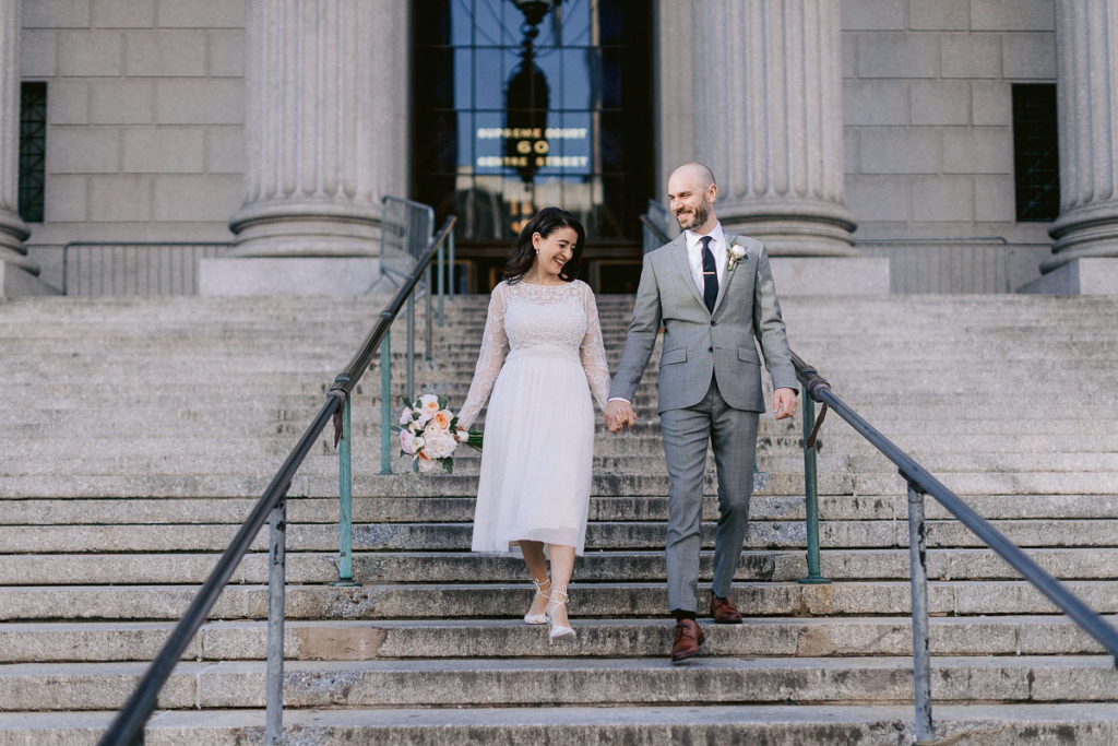husband and wife celebrate their marriage at New York City Hall