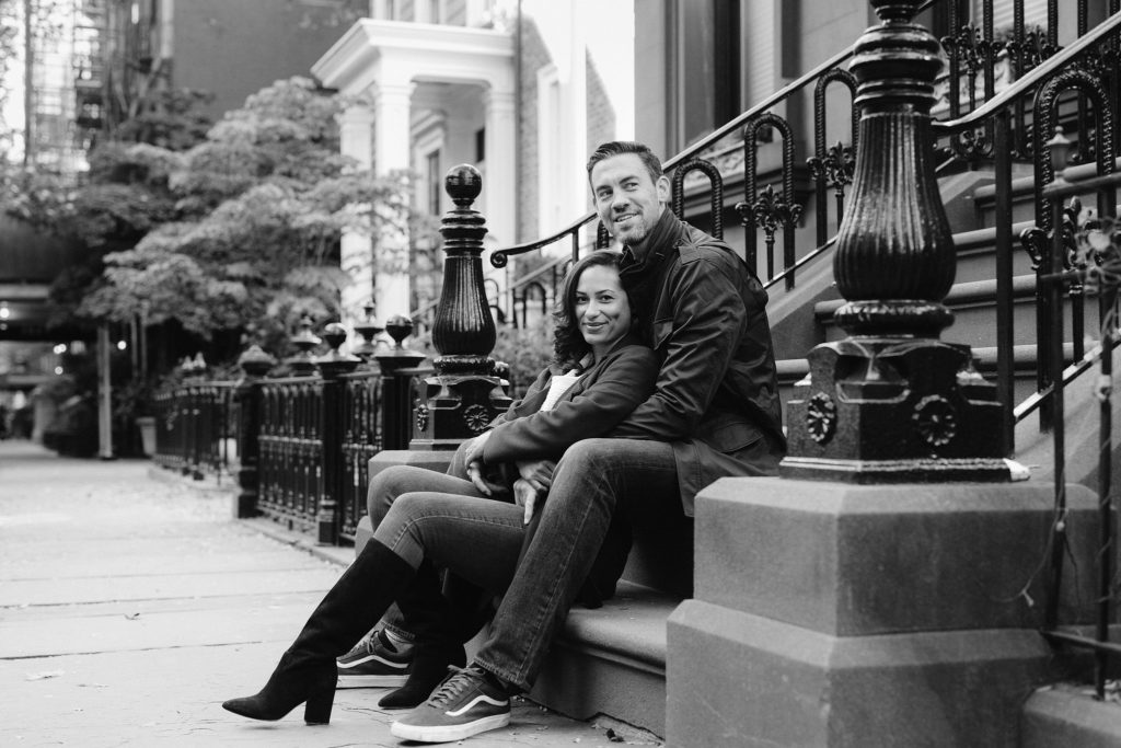 Man and woman sit on the steps of a Brownstone in Brooklyn Heights in NYC. Images by Jenny Fu Studio