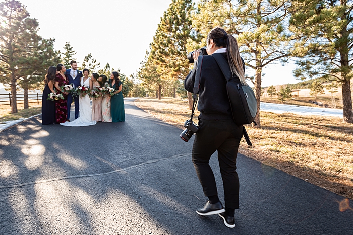 photographer Jenny Fu shoots a wedding party photo in a park
