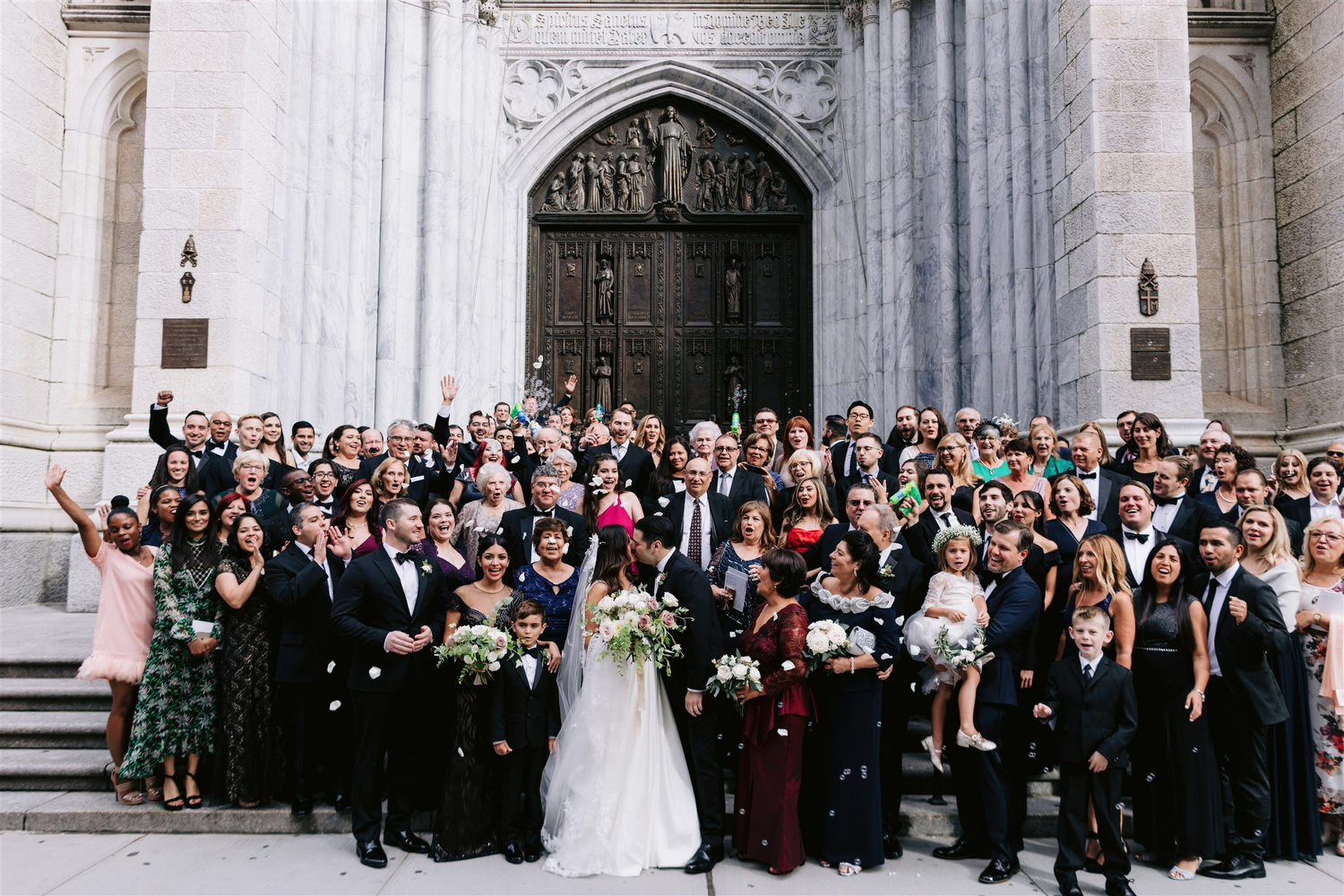 old new york, new york wedding, jenny fu, saint patricks cathedral, large group of wedding guests in front of church, cheering with rose petals, 5th ave, Manhattan