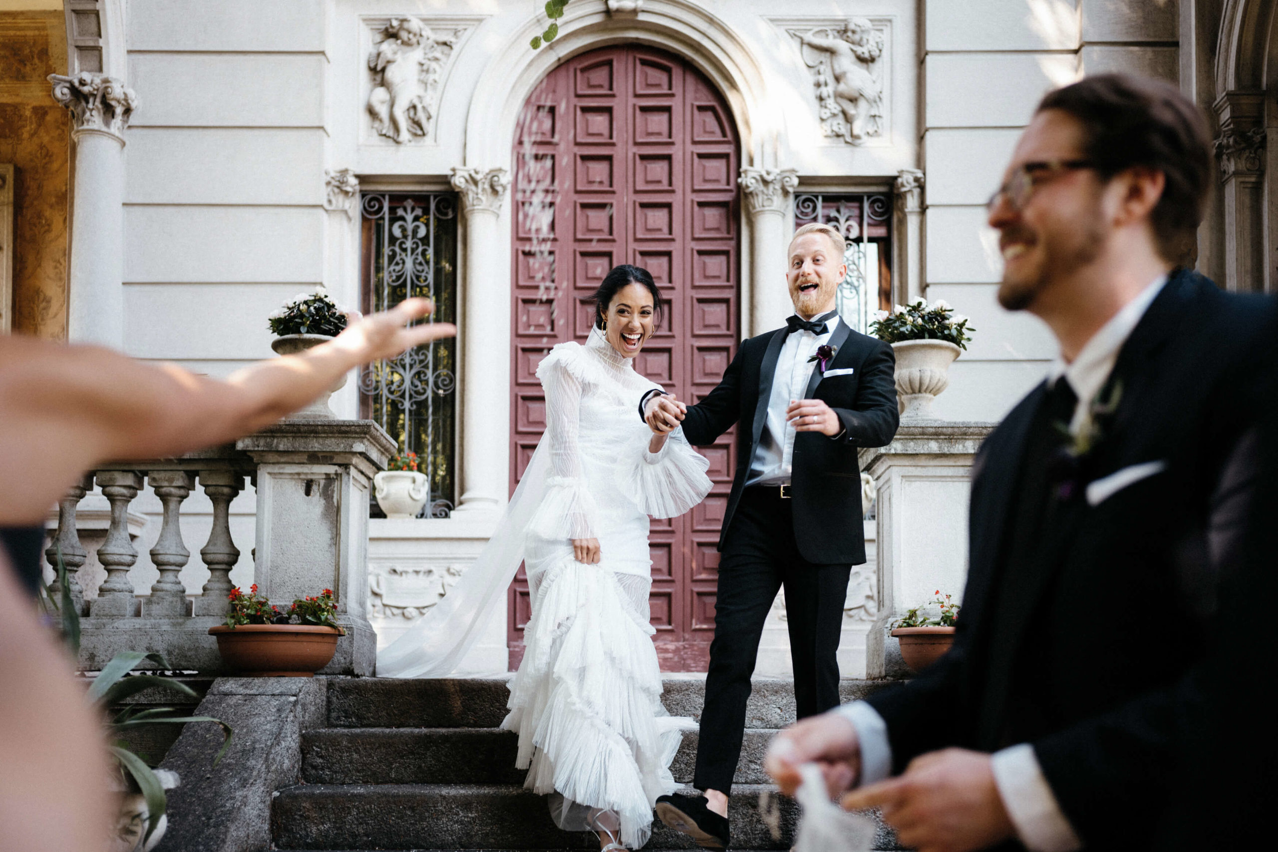 bride and groom exit ceremony at villa in Lake Como on wedding day rice toss
