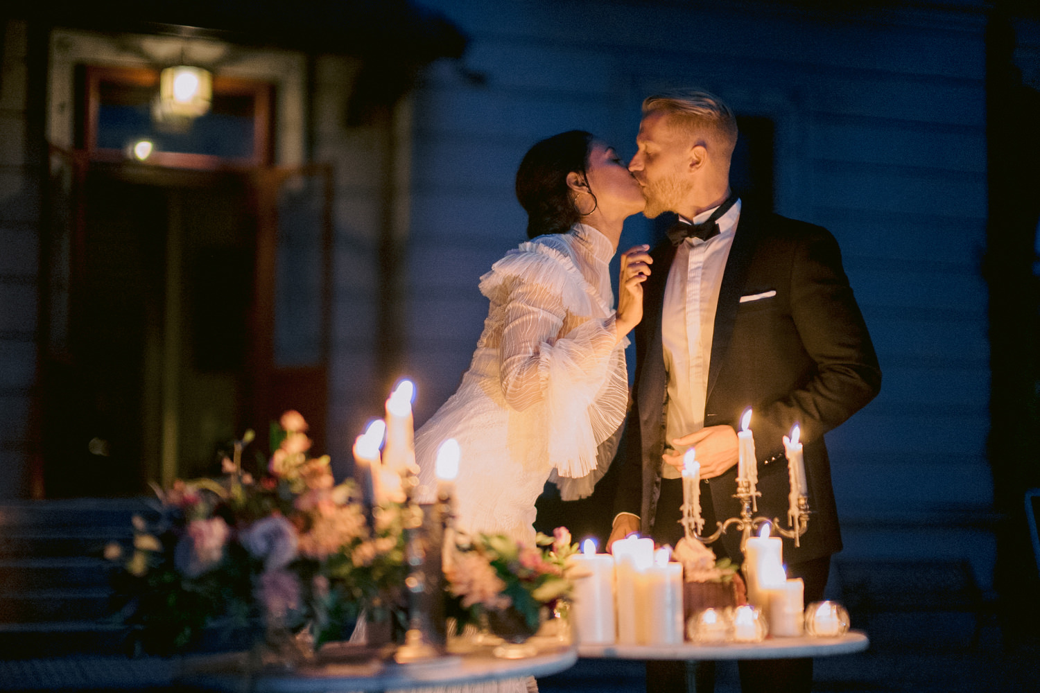 stunning bride and groom share a kiss at their candlelit cake cutting ceremony, Italian destination elopement wedding Lake Como, Italy, fine art, documentary, photojournalistic, editorial wedding photography by Jenny fu