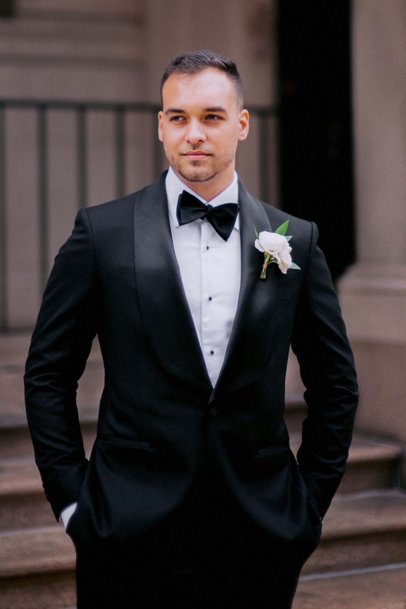 Man wearing a suit with a white boutonniere on wedding day at Providence Public Library