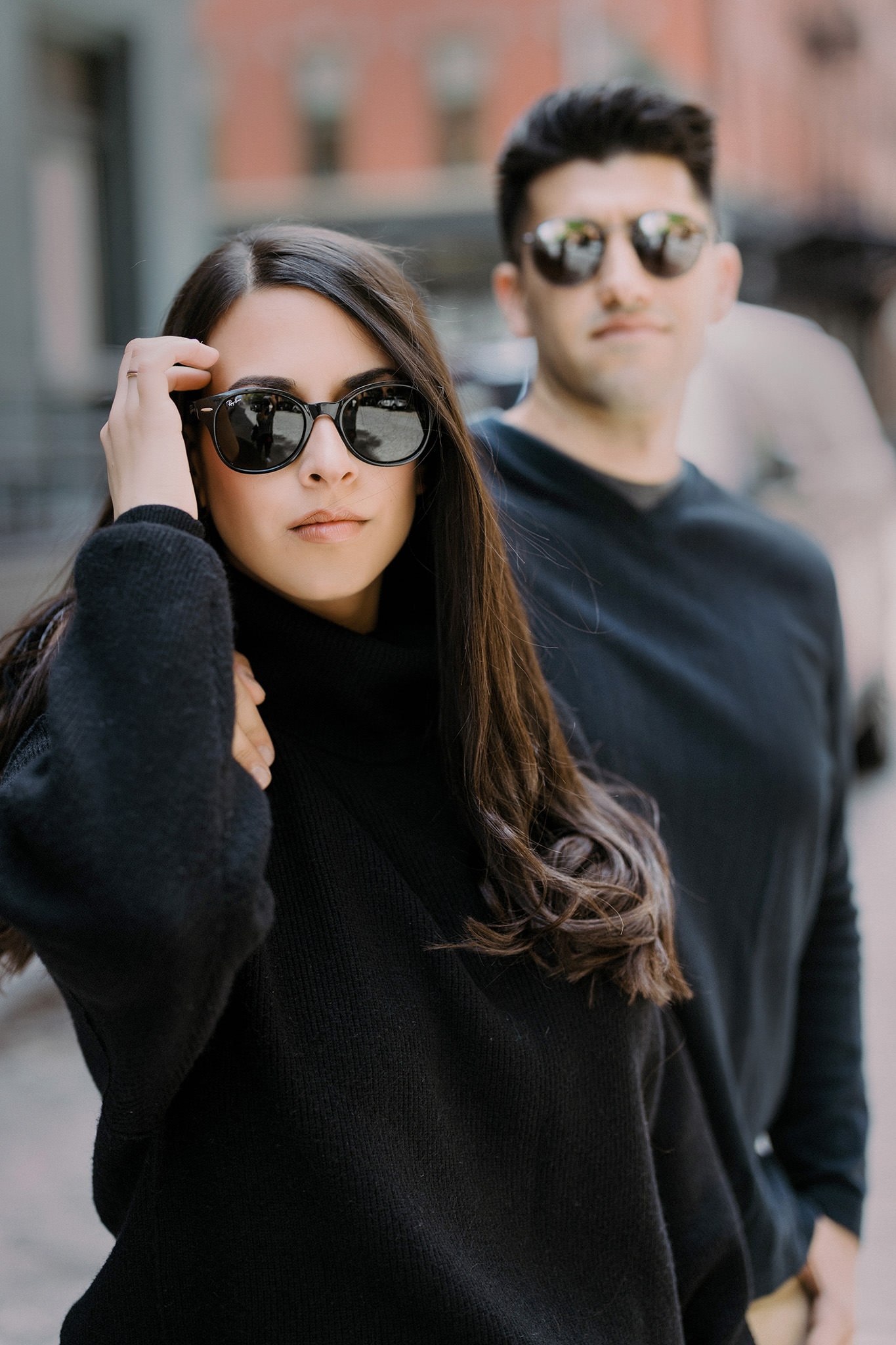 Engaged couple standing together wearing sunglasses in streets of Tribeca