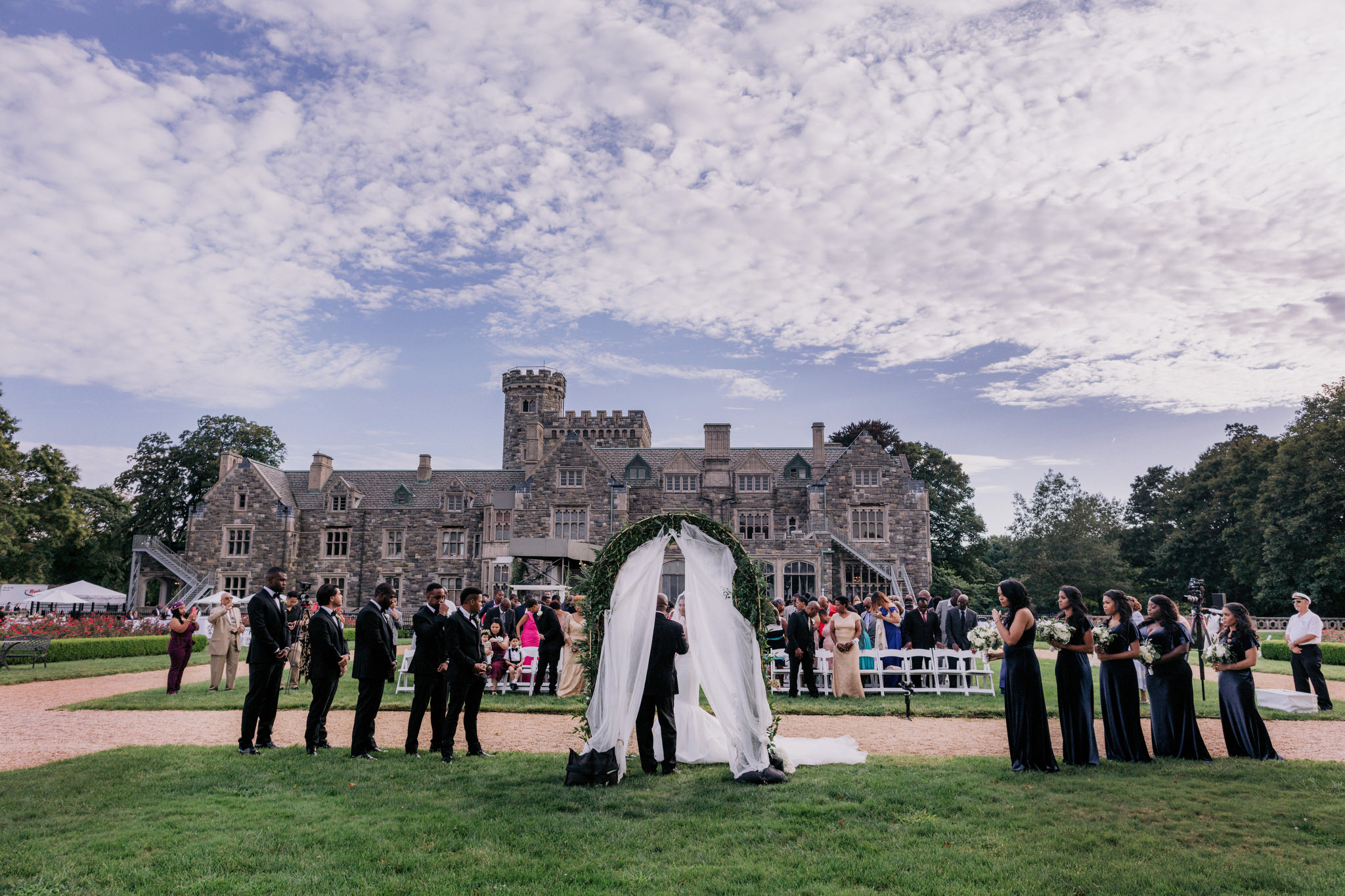 Wedding ceremony in front of Hempstead House castle in Sands Point New York