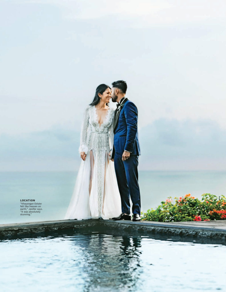 Bride and groom on their wedding day, standing on pool deck with ocean in the background