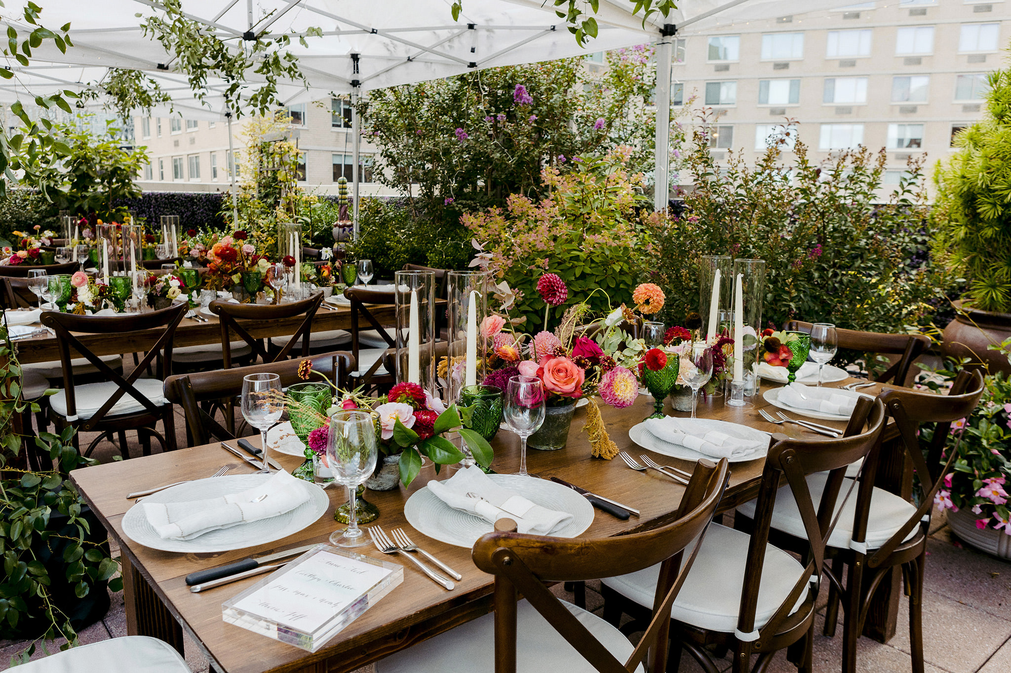 Wedding dinner reception on Manhattan rooftop with flowers and candles