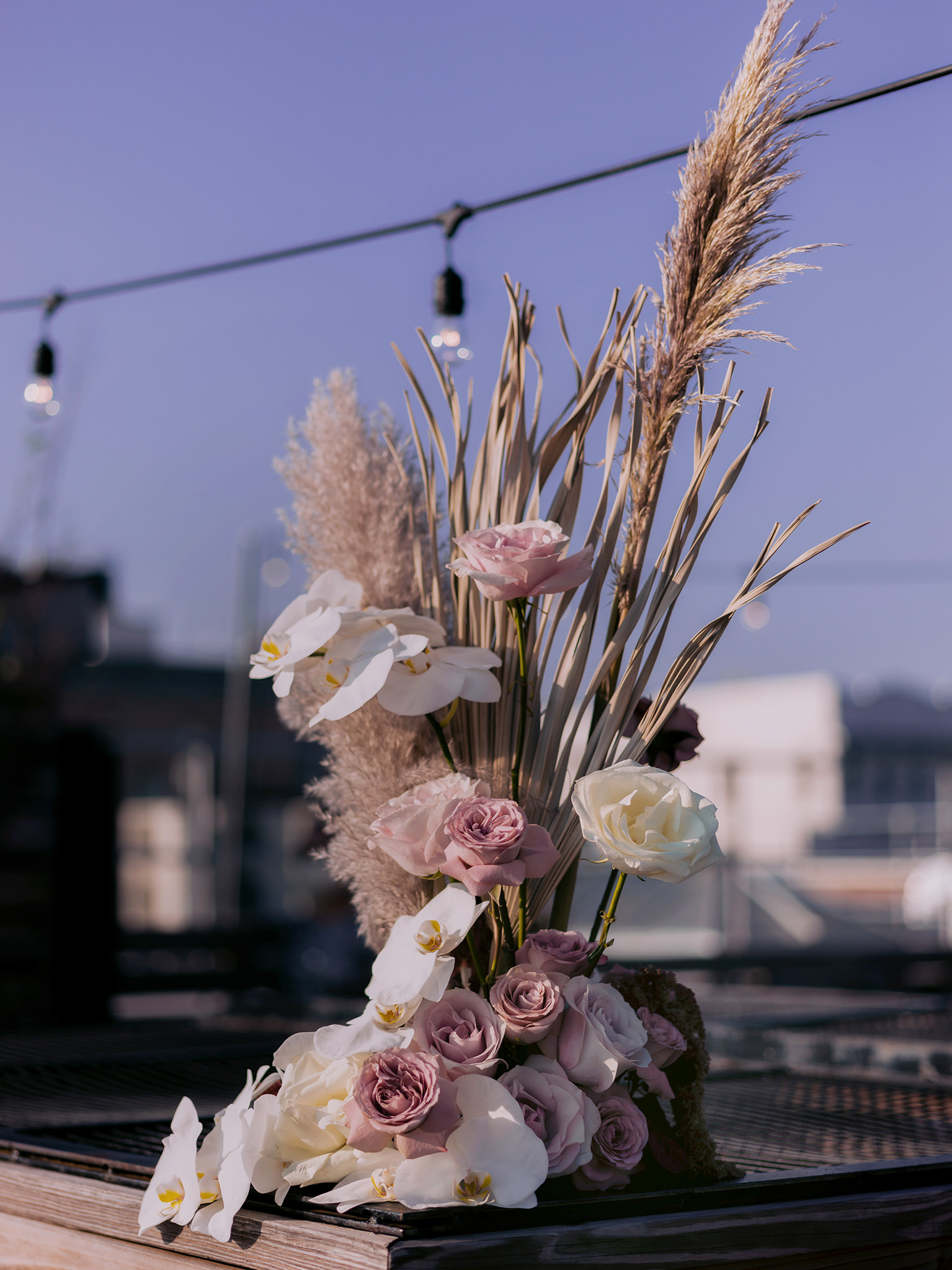 Intricate wedding flowers on a rooftop patio. 