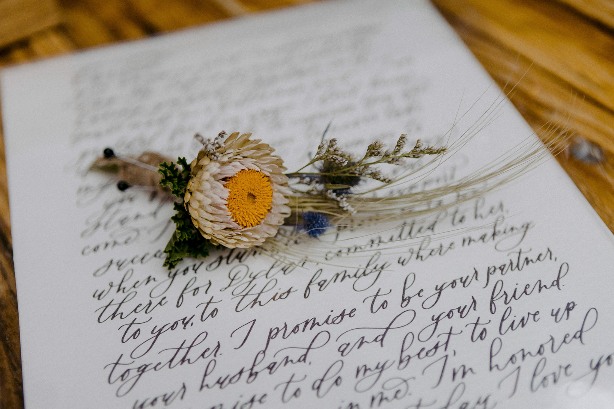 unique groom boutonniere by stems Brooklyn laying our calligraphy vows