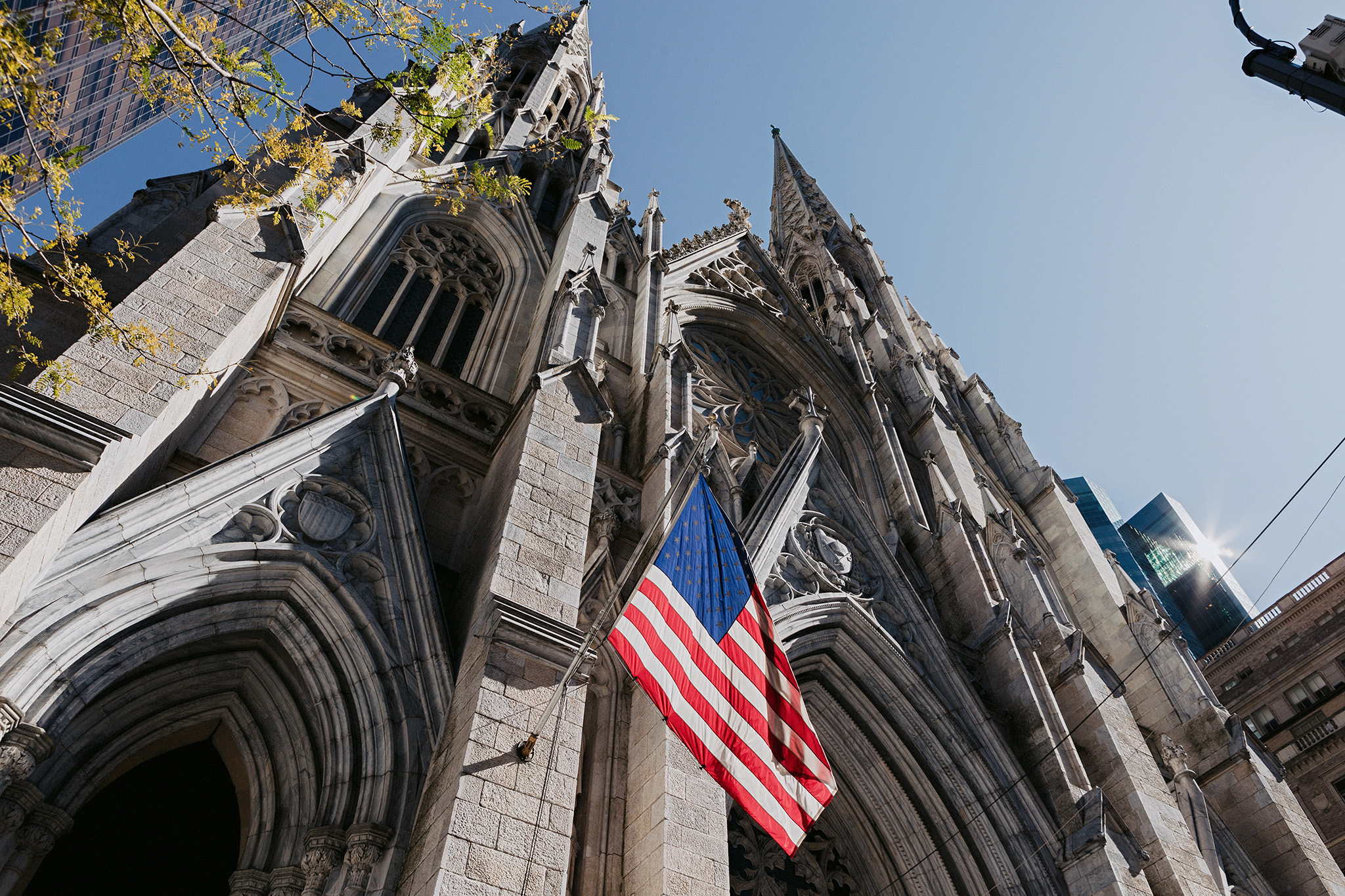 Beautiful sunny day outside of St. Patrick's Cathedral with American flag.
