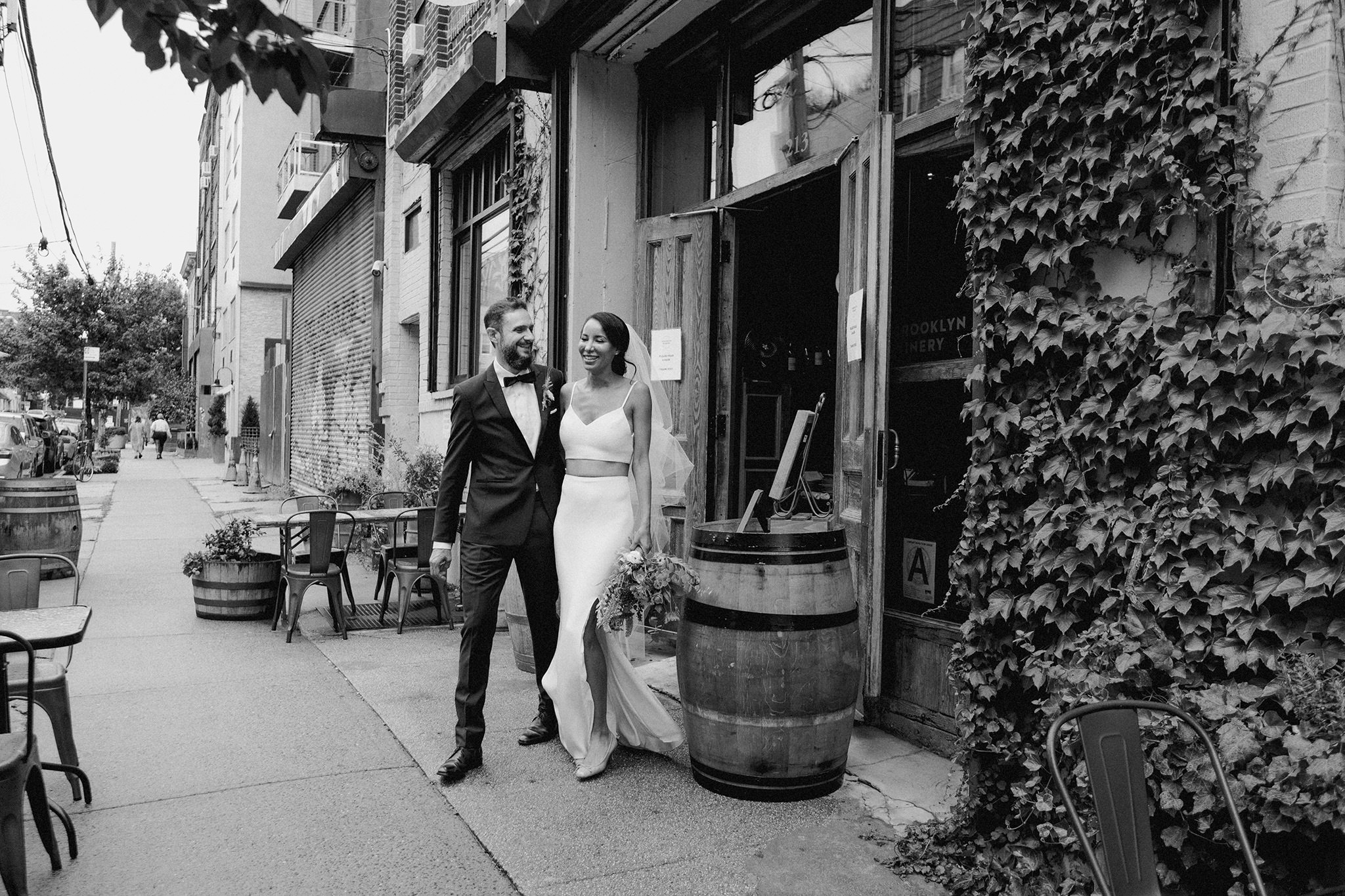 newly married couple exits their reception at Brooklyn winery laughing