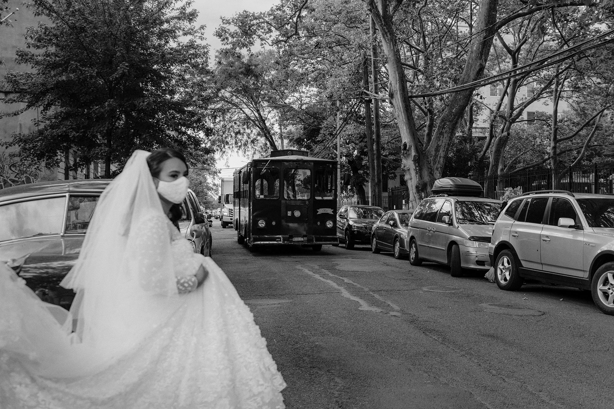 Bride walking to her wedding ceremony with a mask covering her mouth