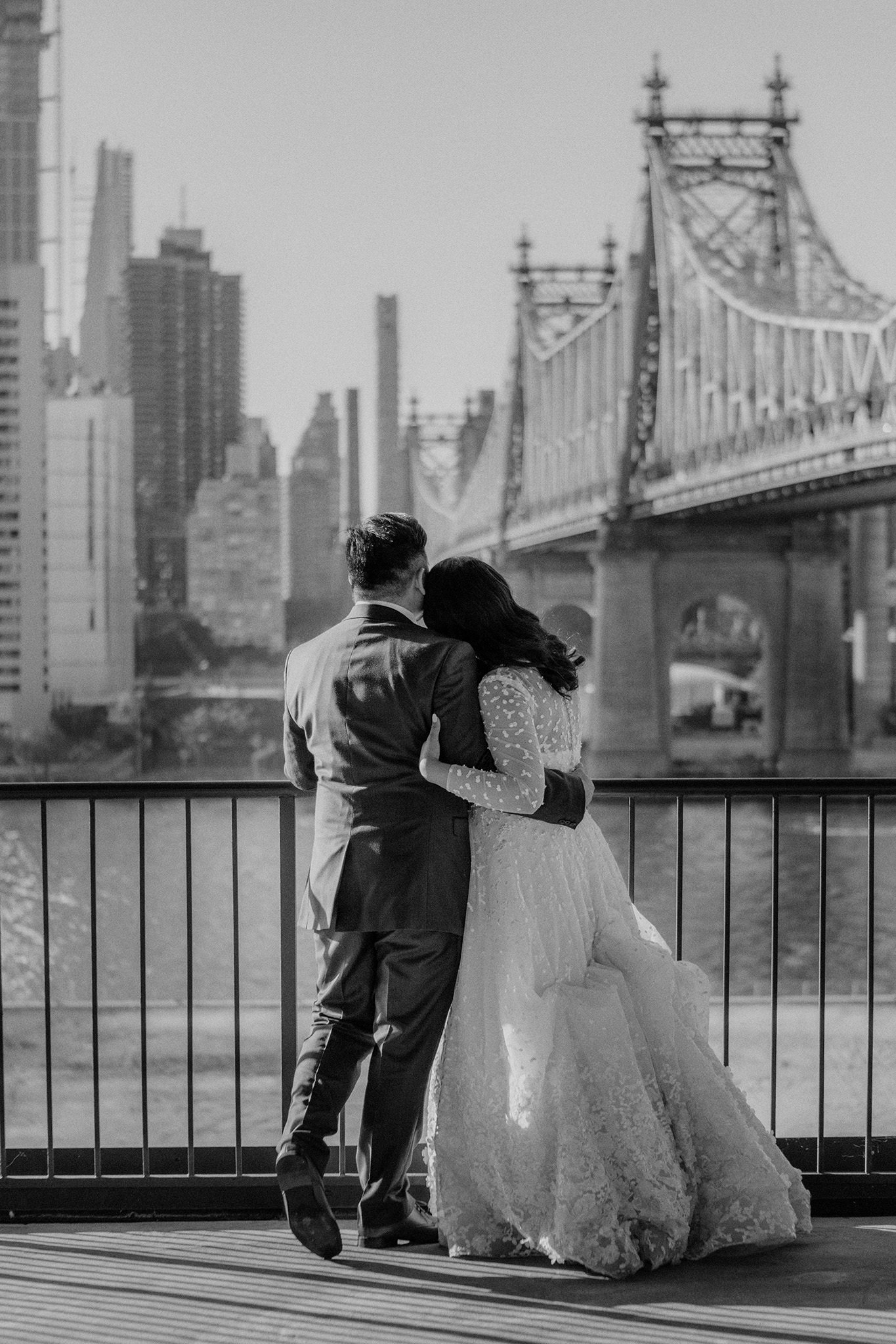 Bride and groom looking at the Queensboro Bridge
