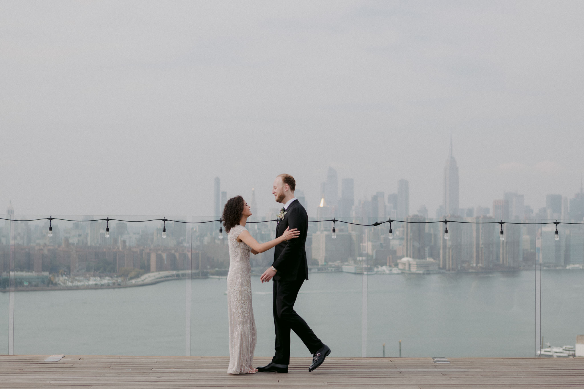 A couple embraces during their first look on the rooftop at the Willam Vale, wedding venue