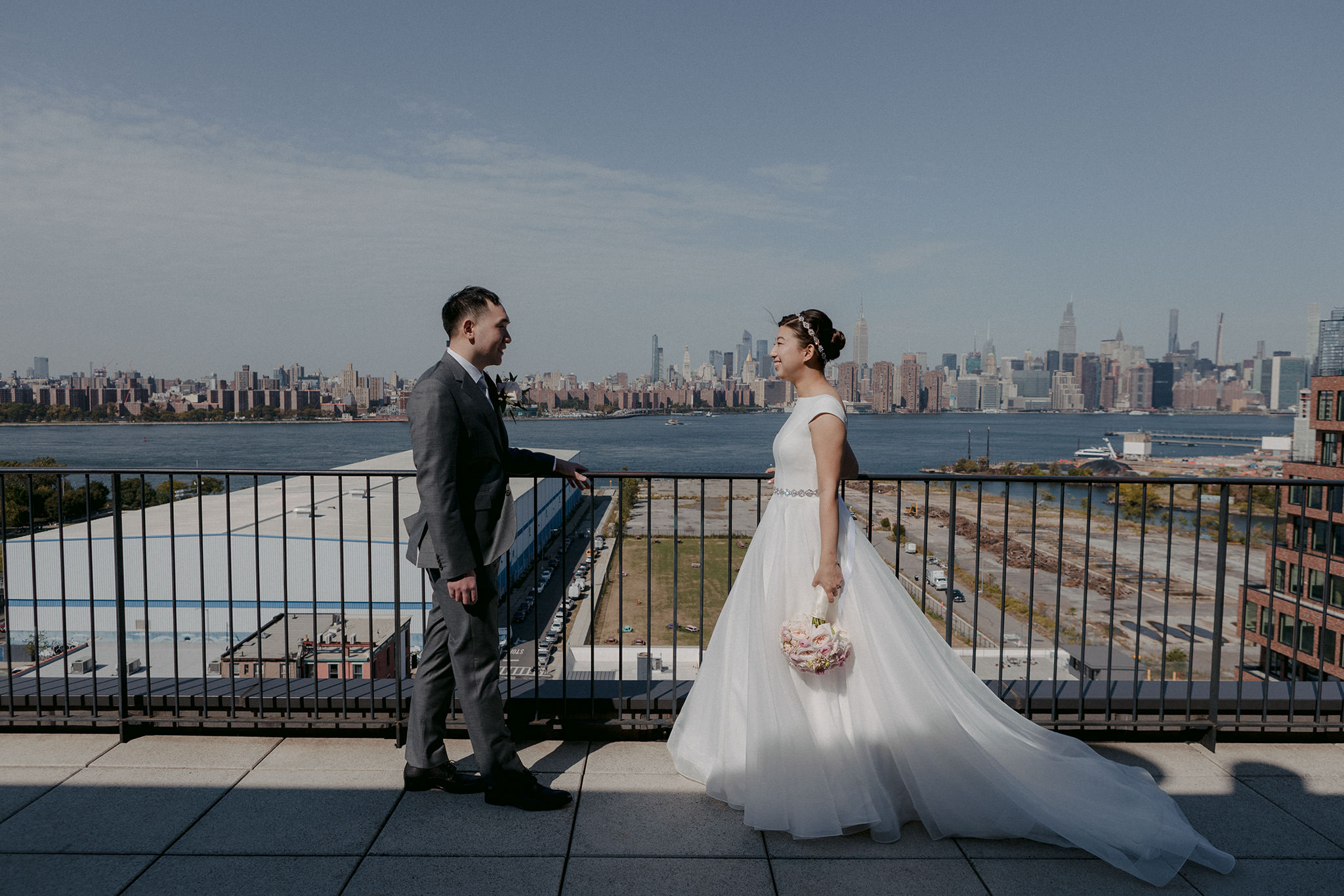 groom and bride see each other for the first time at their venue The Wythe Hotel with Manhattan skyline in background