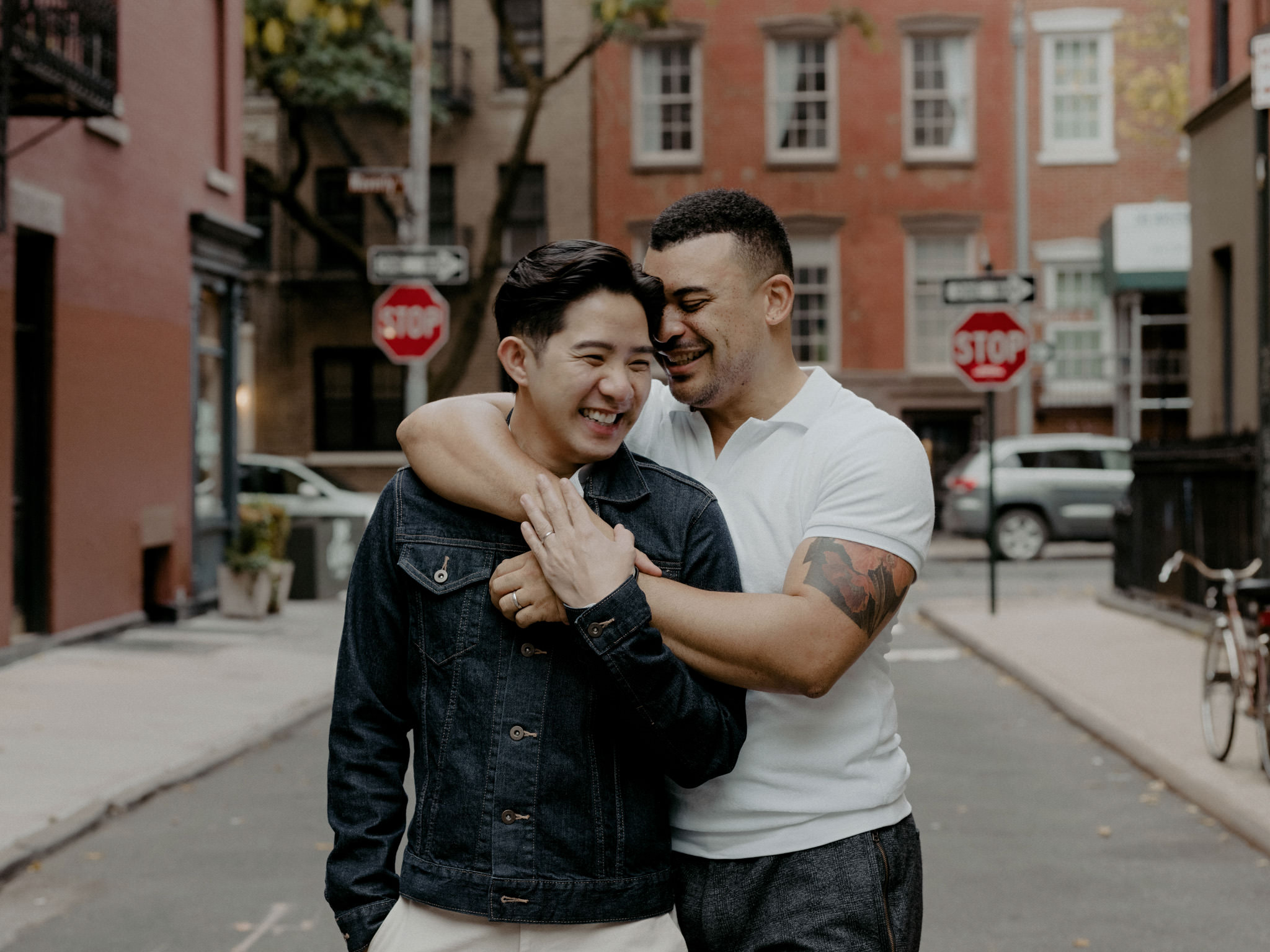 Groom and groom hugging in the street NYC