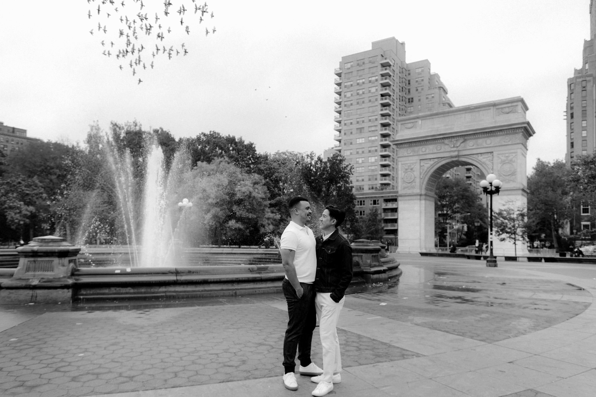 Groom and groom married laughing in love at Washington Square Park in NYC