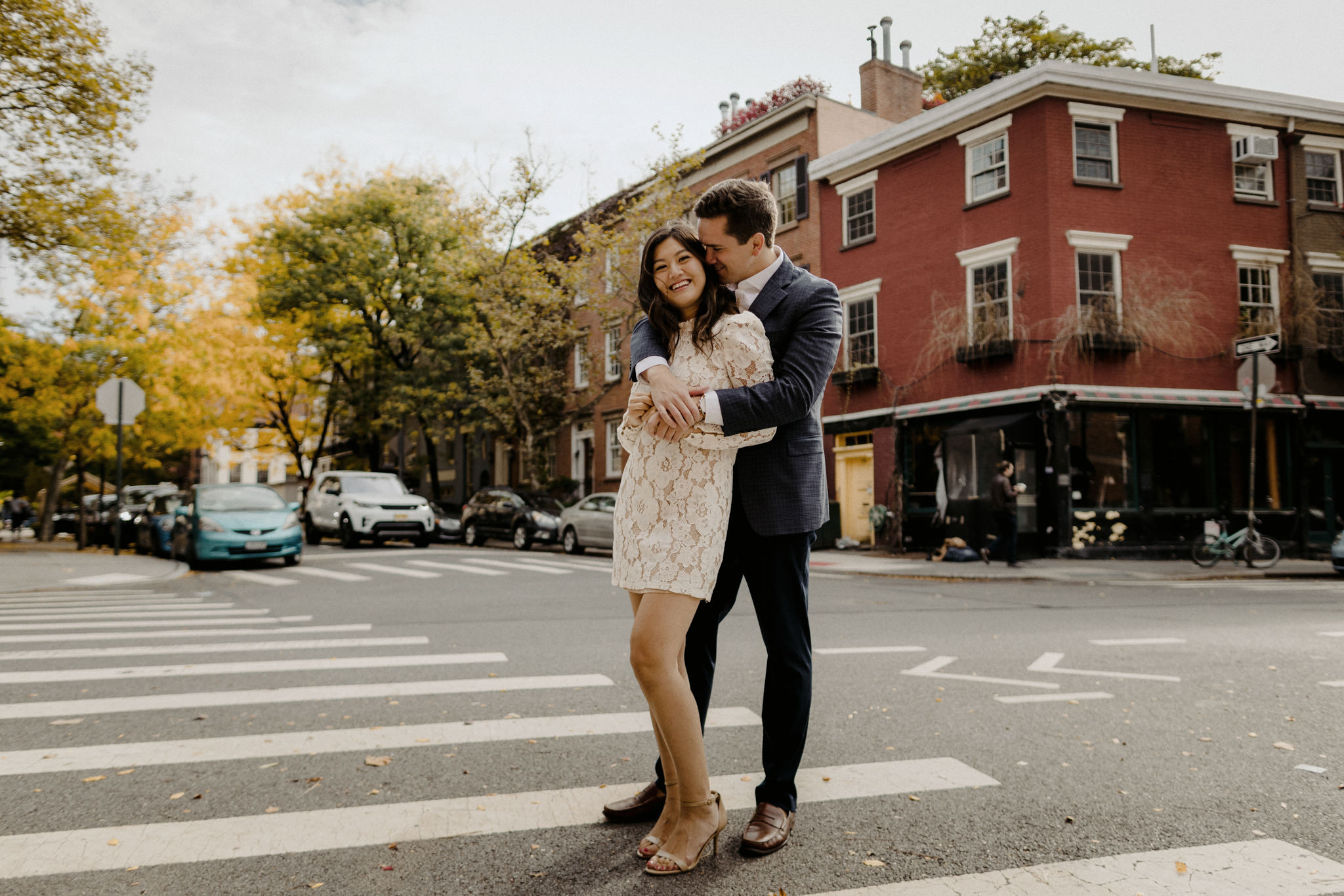 Young couple hugging in front of a brick buidling in the West Village on New York City