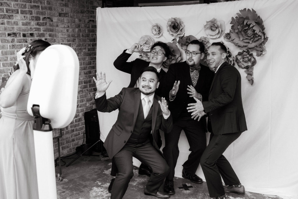 Wedding party making silly gestures for a photo booth