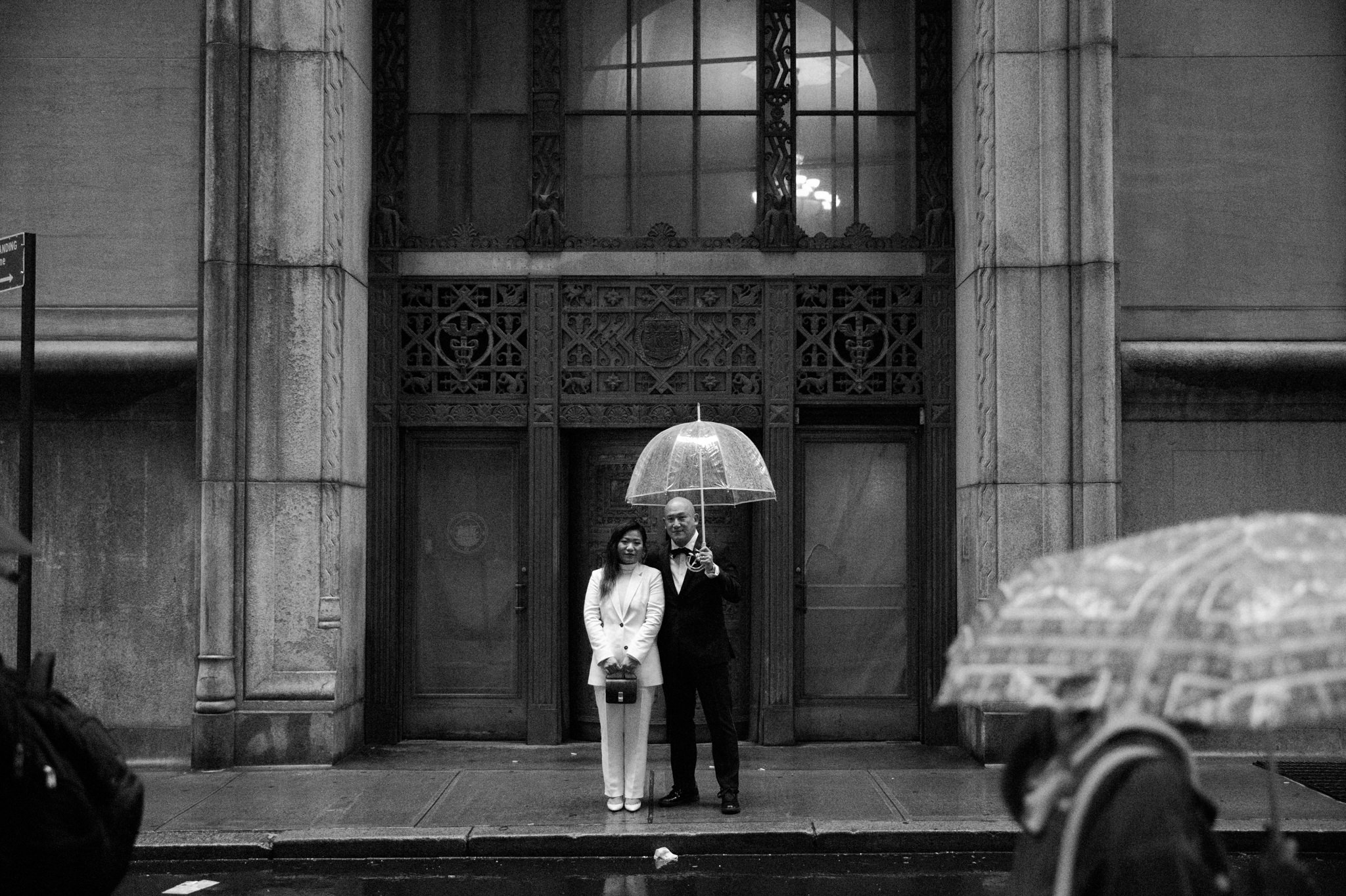 Man and wife on their wedding day under an umbrella