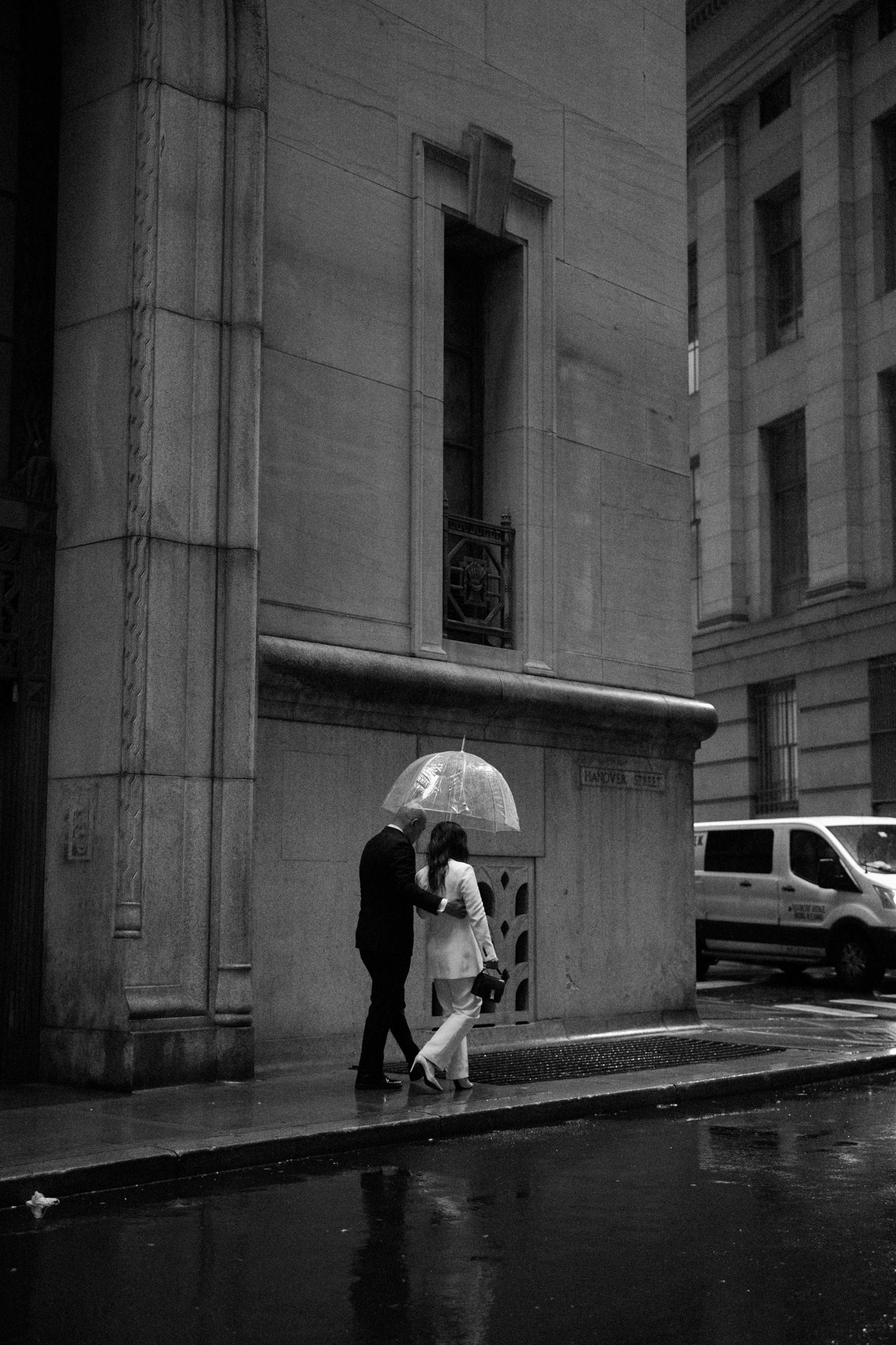 Bride and groom walk in the rain in New York City