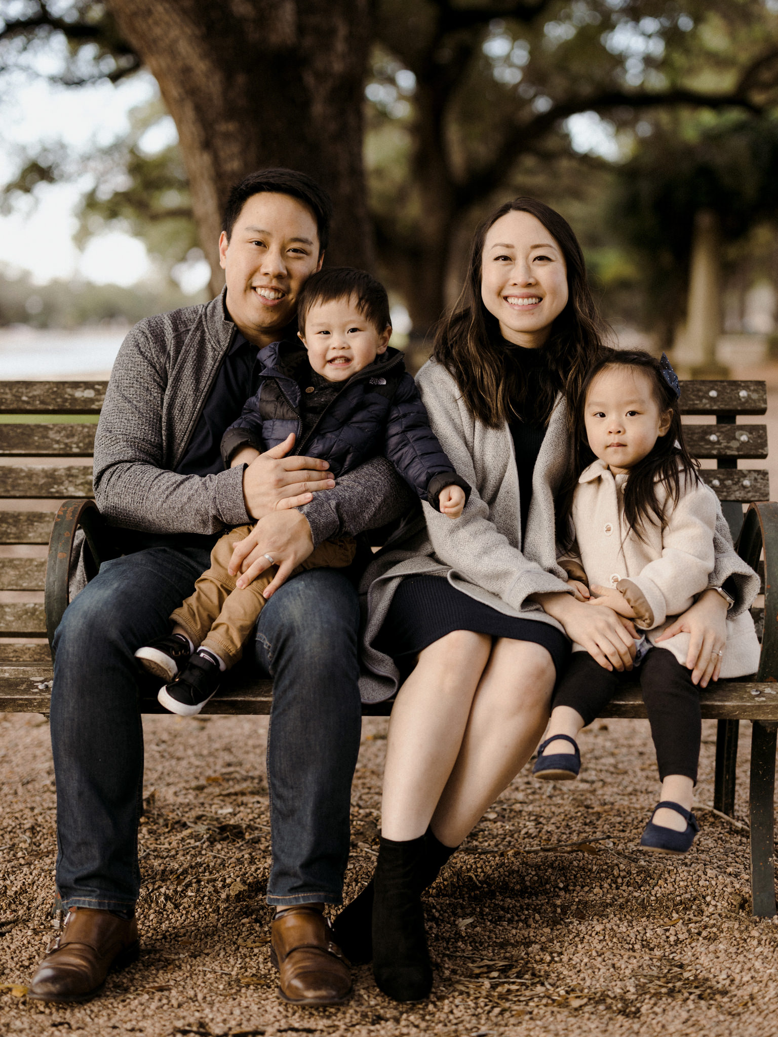 Husband and wife with the children on a park bench