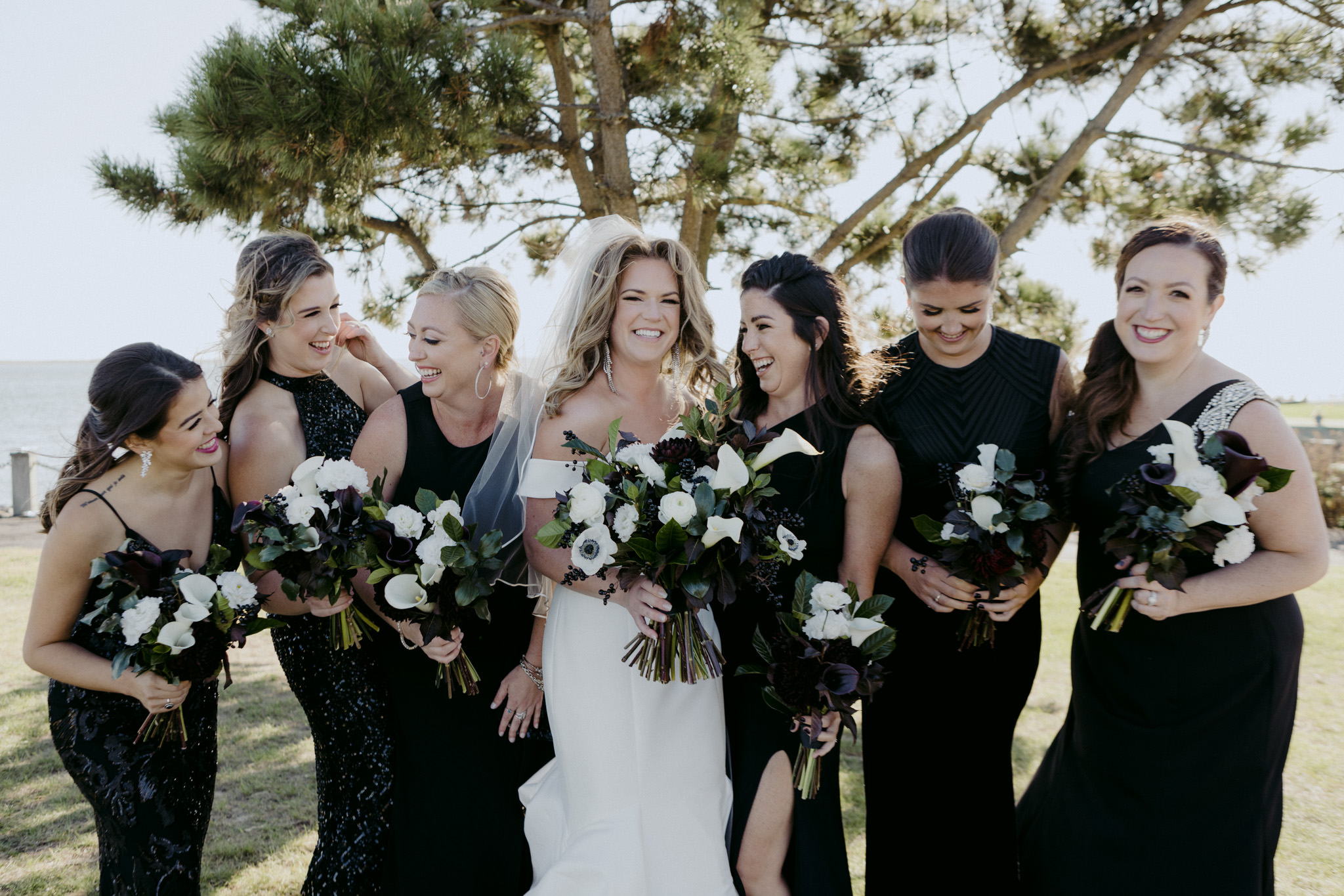 Bride and her bridesmaids laugh in the sun at the Riviera Waterfront Mansion