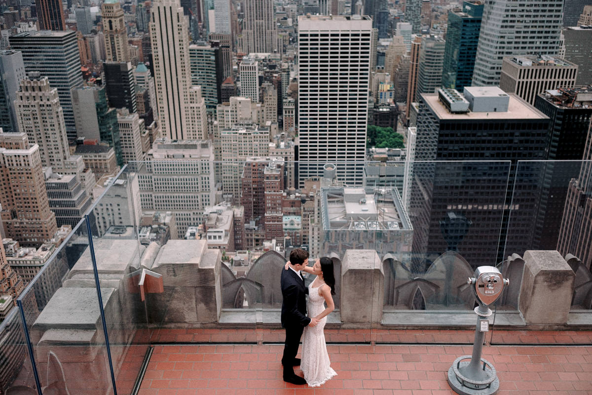 Bride and groom kissing at the Top of the Rock at 30 Rockefeller Plaza