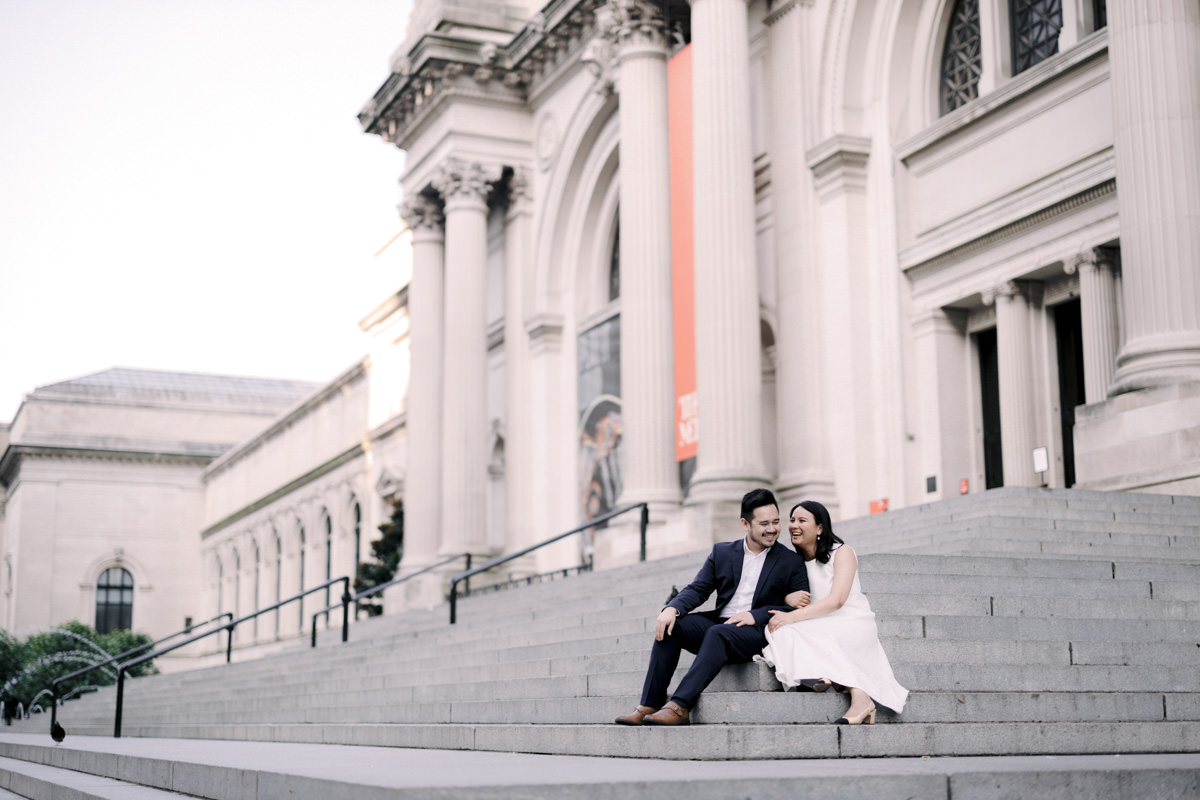 A bride and groom taking wedding photos on the steps of the Metropolitan Museum of Art