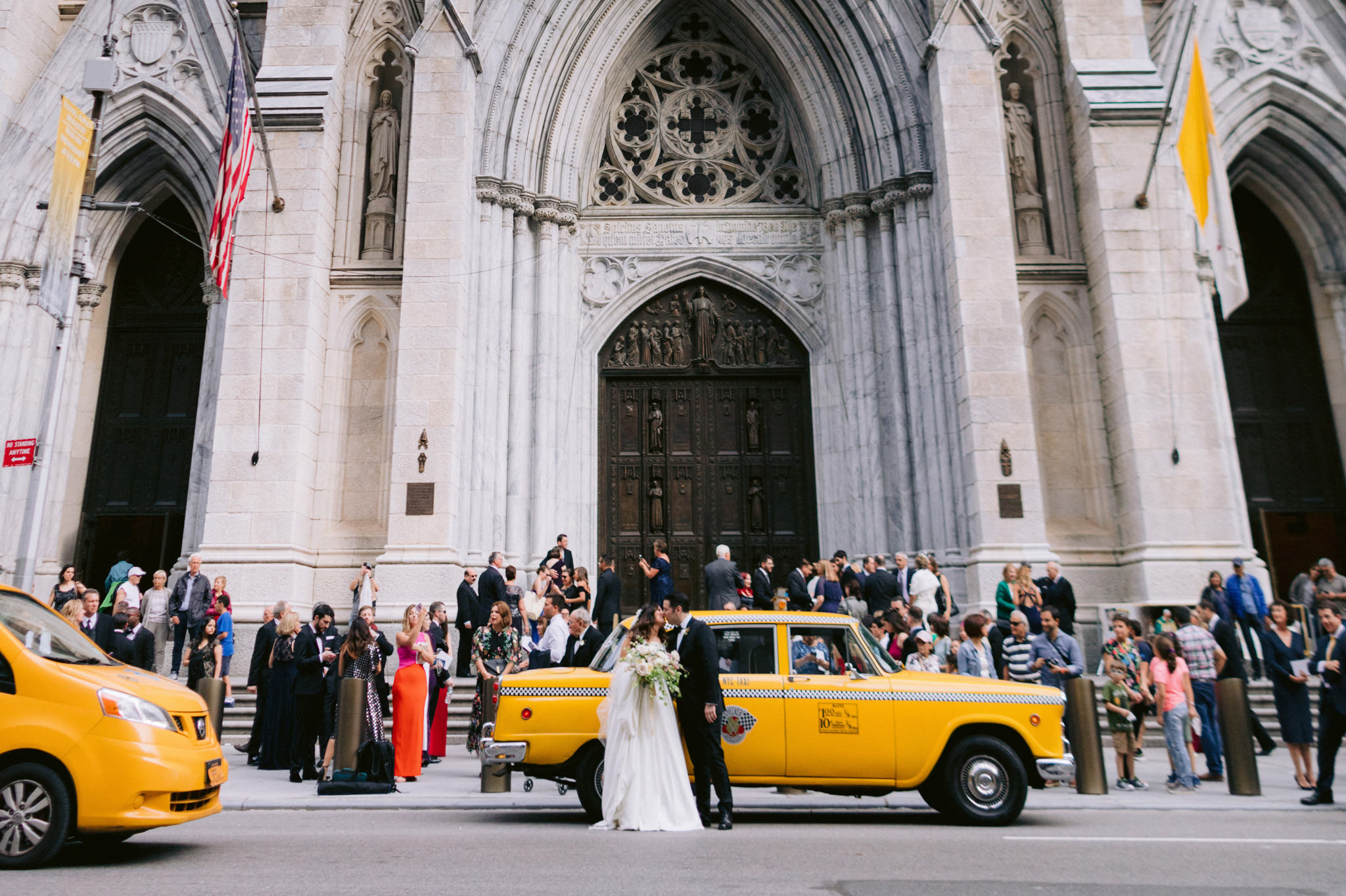 Bride and groom kissing outside of the St.Patrick's Cathedral in New York City