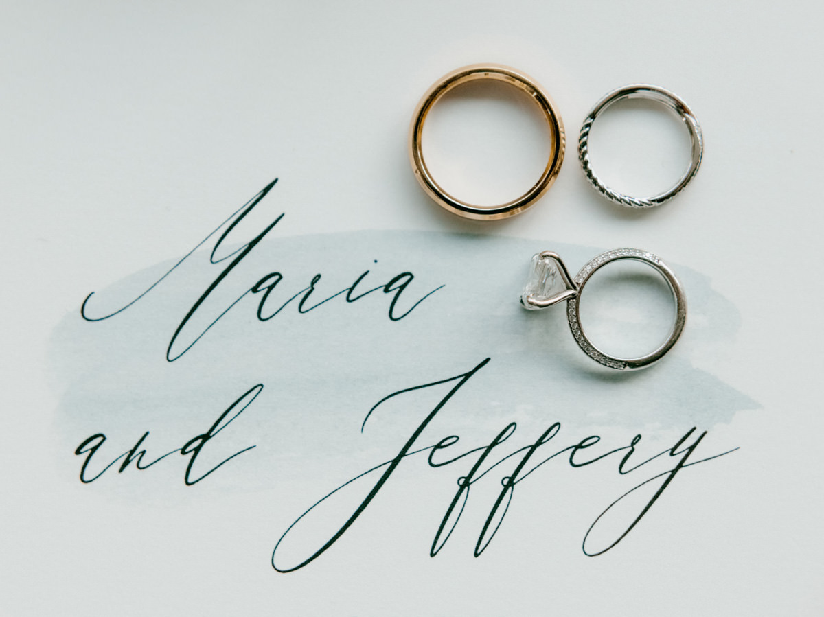 A diamond engagement ring and wedding bands. Image by Jenny Fu Studio