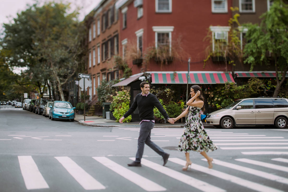 A young couple crosses at a crosswalk in the West Village