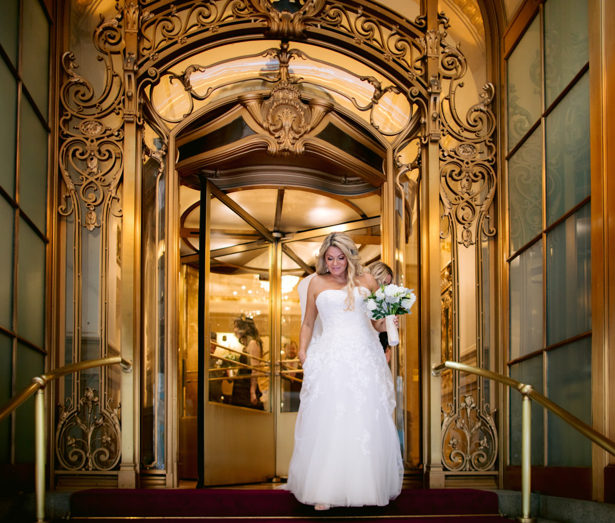 Bride in a gown standing outside of the St.Regis hotel