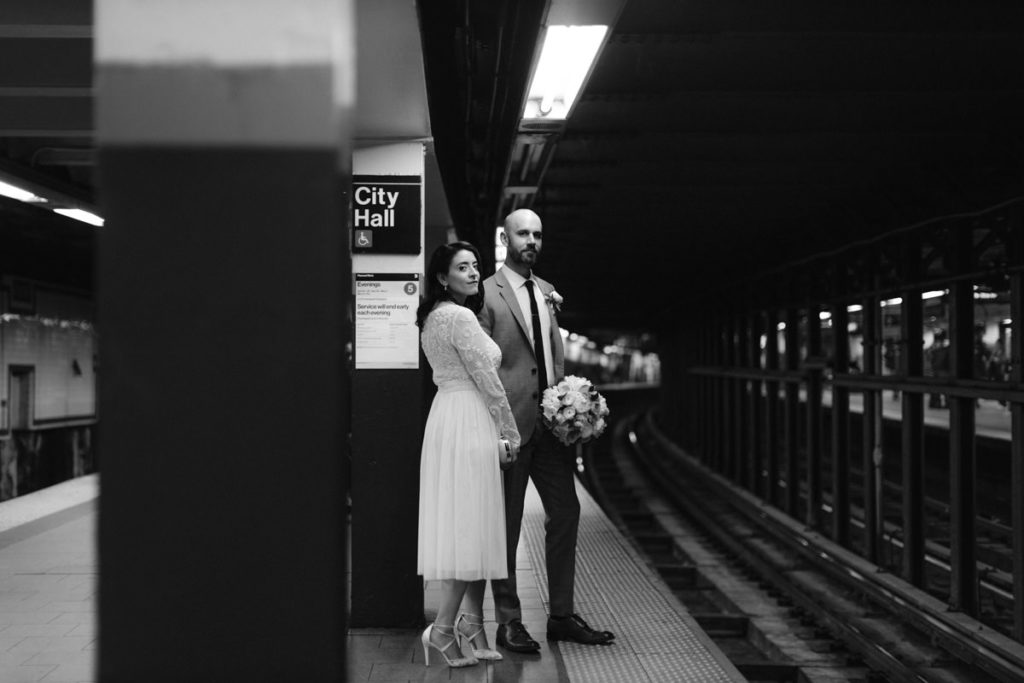 Bride and groom taking the train at city hall stop in NYC