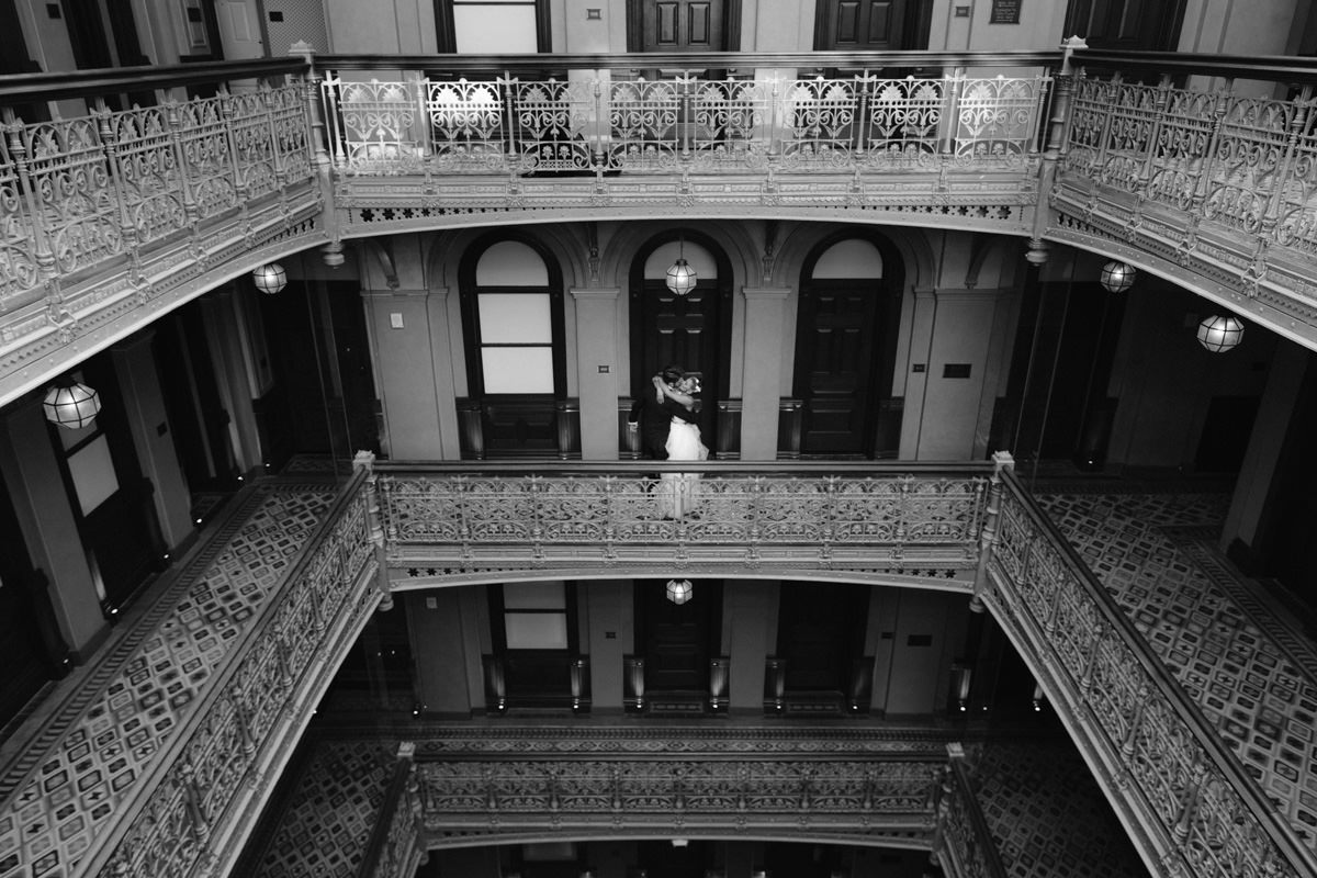 A bride and groom kiss in a stairwell at an iconic Lower Manhattan boutique hotel