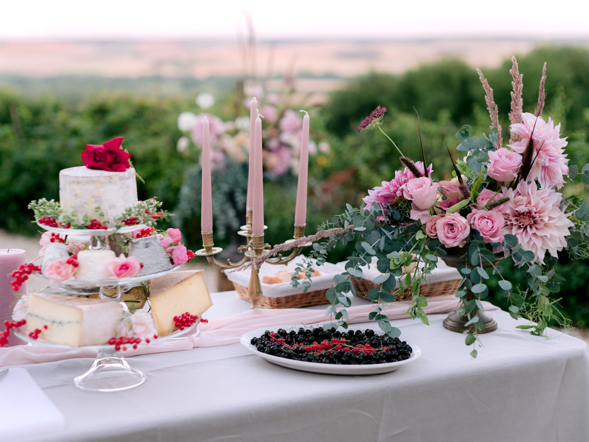 fruits and cheeses line a table at a destination wedding in France