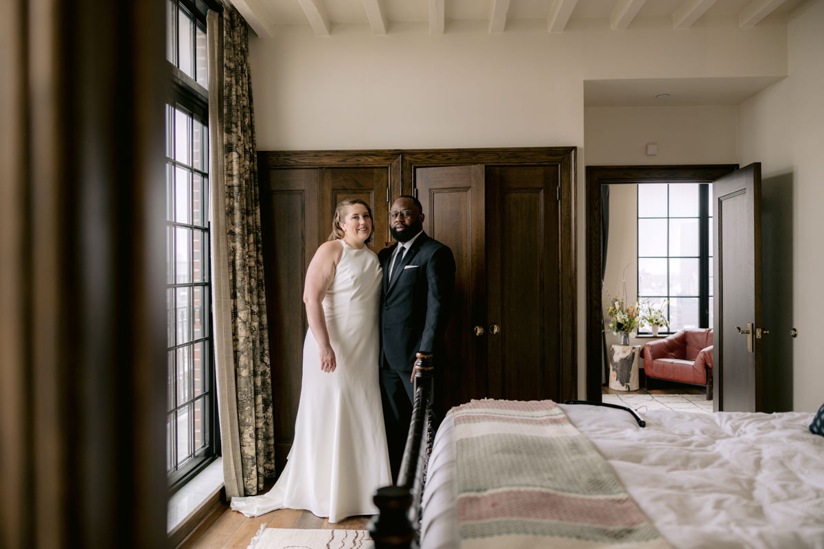 A biracial couple sits in a boutique hotel in Lower Manhattan on their wedding day